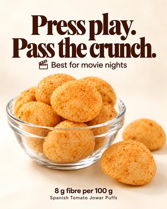 Press play. Pass the crunch. Best for movie nights — Spanish Tomato Jowar Puffs in a glass bowl, 8 g fibre per 100 g.