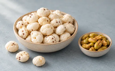 A bowl of roasted makhana beside a smaller bowl of roasted edamame